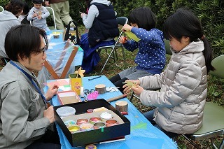大人と子供が向かい合って作業している
